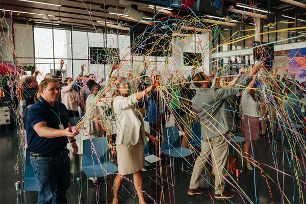 group of people firing confetti cannons