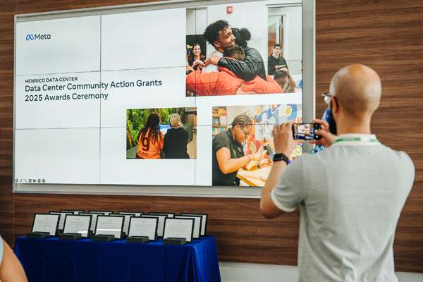 man taking a photo of a presentation slide